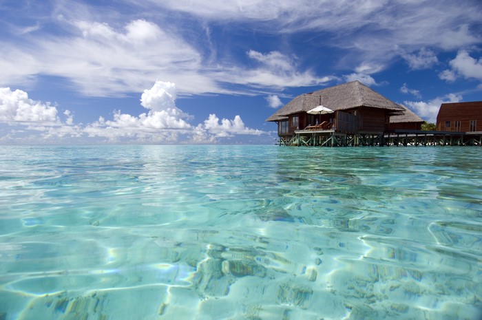 Overwater bungalows in the Maldives with clear turquoise water