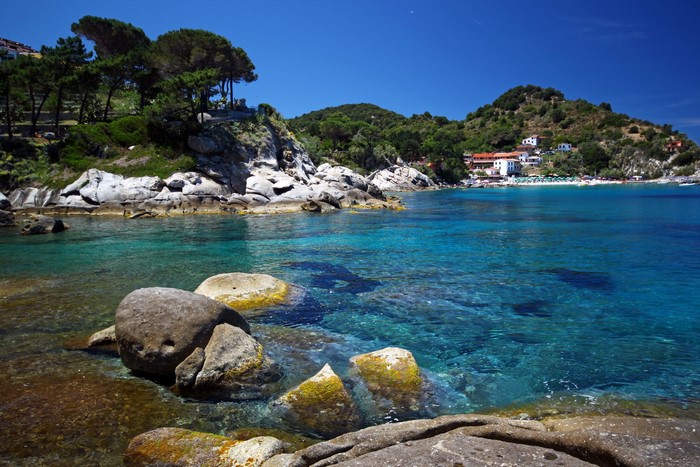 Rocky Coastline with Turquoise Water and Buildings in Italy