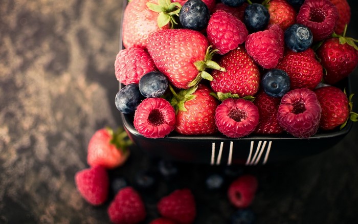 Bowl of fresh strawberries, raspberries, and blueberries