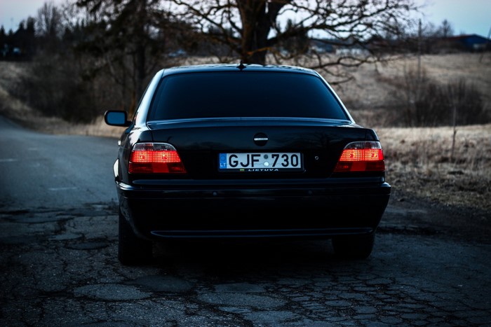 Black BMW 740i E38 from behind