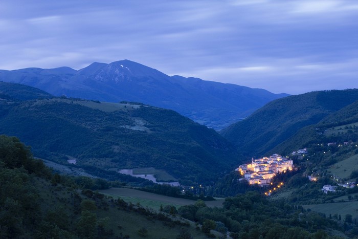 Town in a valley in Umbria, Italy at dusk