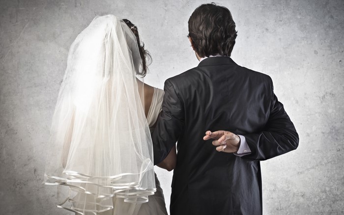 Bride and Groom with Crossed Fingers