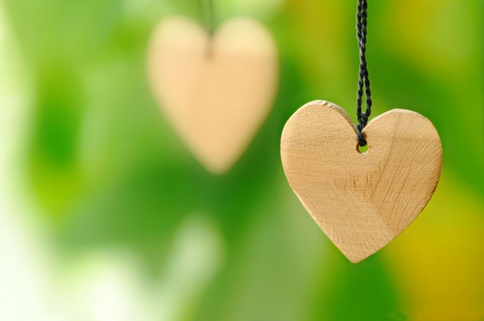 Two wooden hearts hanging on strings
