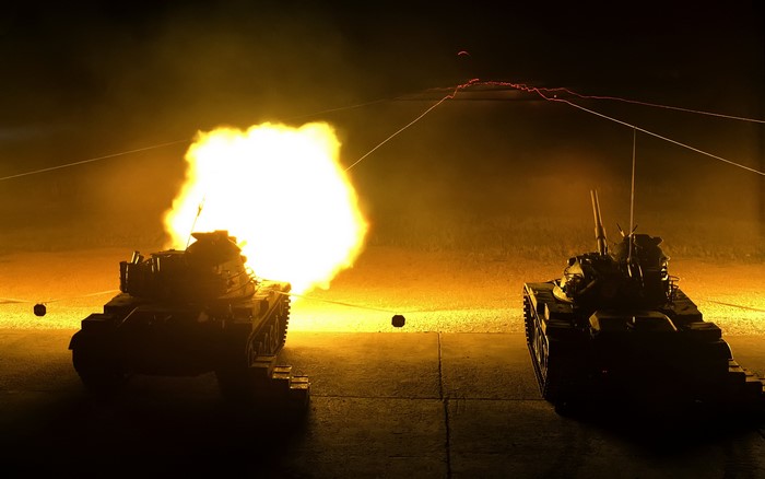 Tanks firing at night with explosions
