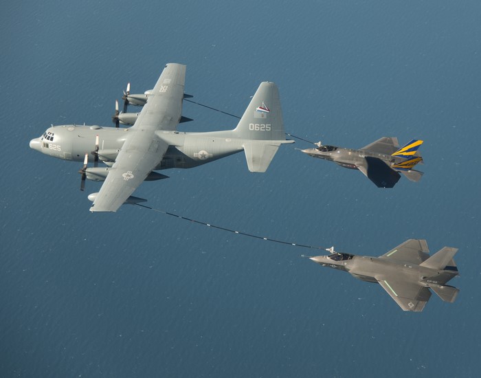 KC-130 refueling two F-35 fighter jets