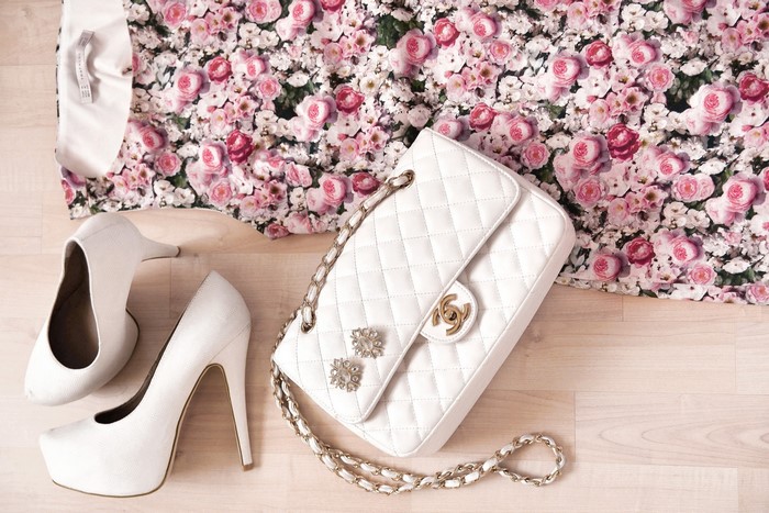 Chanel handbag and white stilettos with floral dress