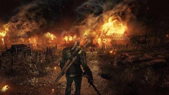 Geralt of Rivia in a burning village from The Witcher 3