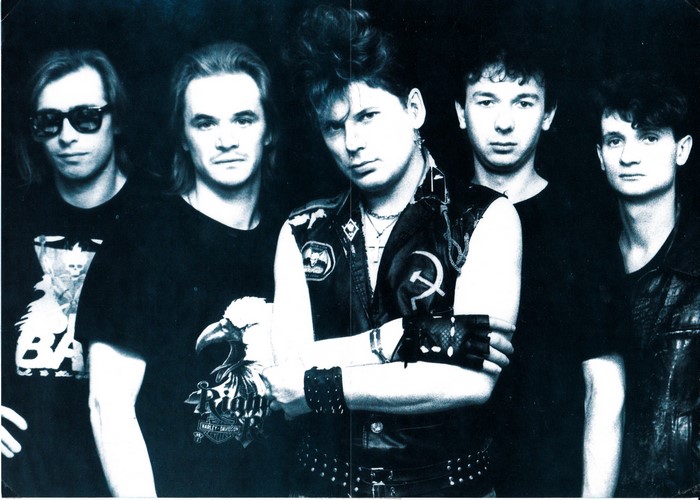 Five men in a band posing for a photo