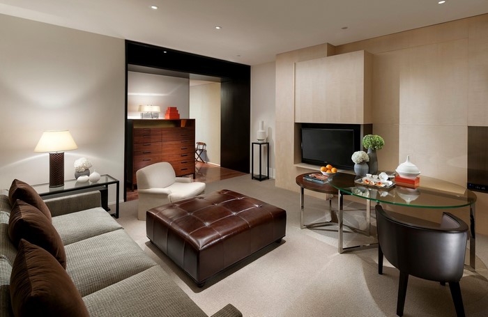 Living room with sofa, ottoman, and TV