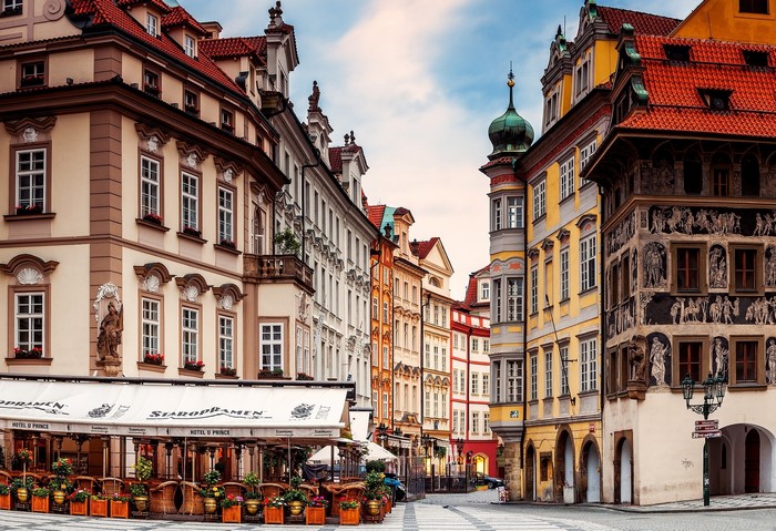 Prague street with historic buildings and outdoor cafe