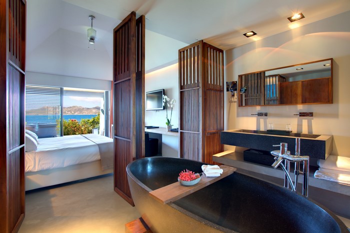 Luxury hotel bedroom and bathroom with ocean view