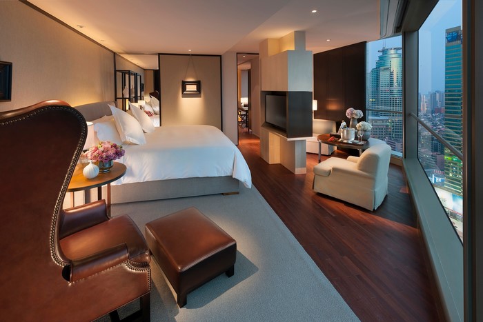 Luxury hotel bedroom with city view