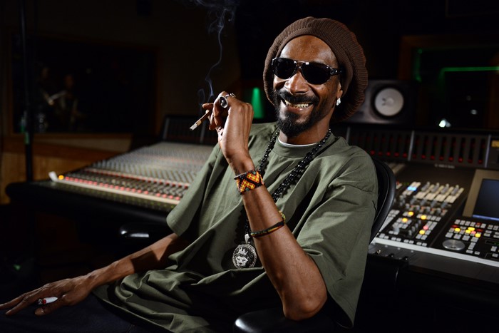 Snoop Dogg in a recording studio smoking