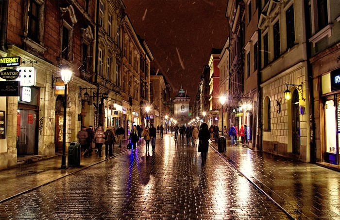 People walking on a wet street at night in Poland