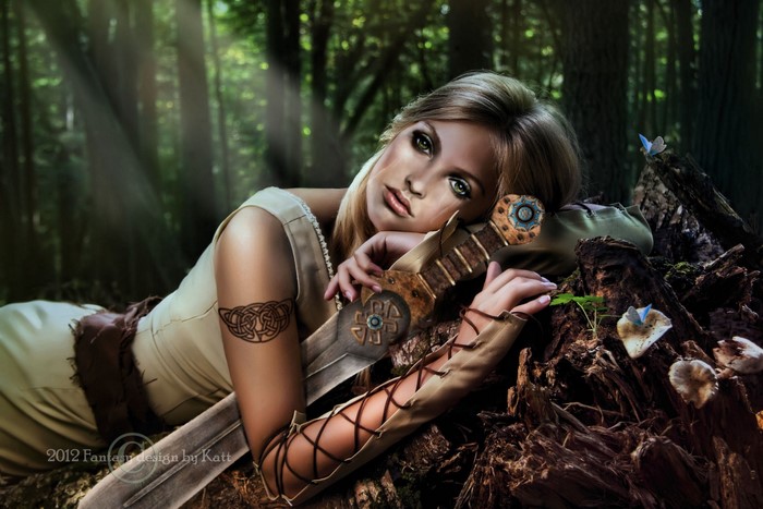 Warrior woman with sword in forest