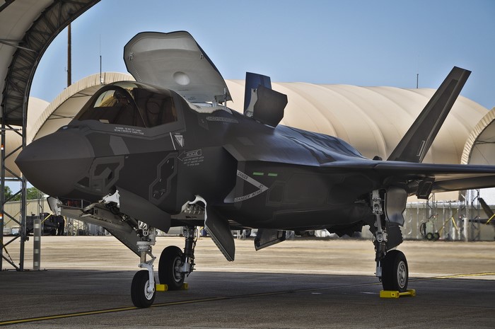F-35 fighter jet parked under a hangar