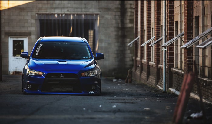 Blue Mitsubishi Lancer in Alley