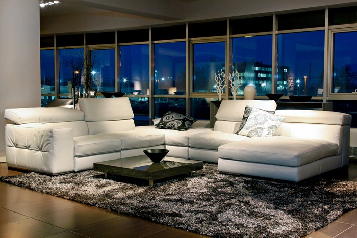 Modern living room with white sectional sofa and large windows