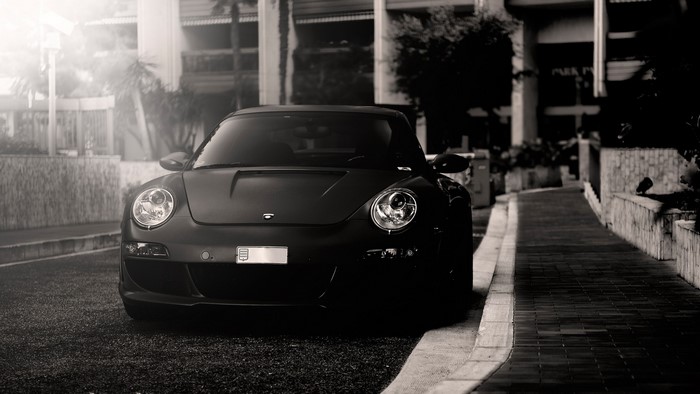 Black Porsche parked on a street