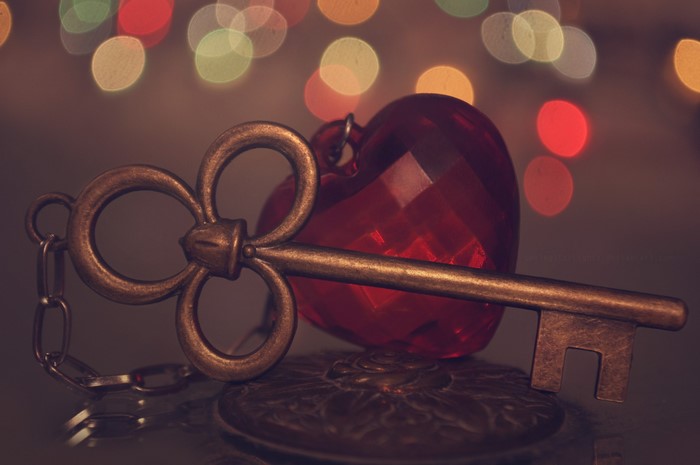 Antique key and red heart ornament with bokeh lights
