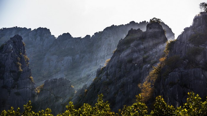 Jagged mountain peaks with sun rays in Thailand