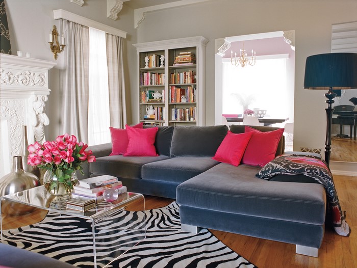Living room with gray sectional sofa and pink pillows