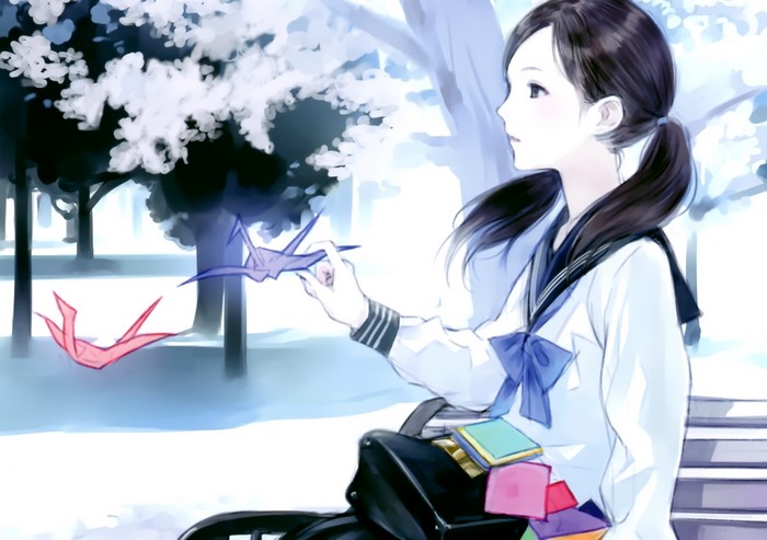 Girl in school uniform with origami cranes