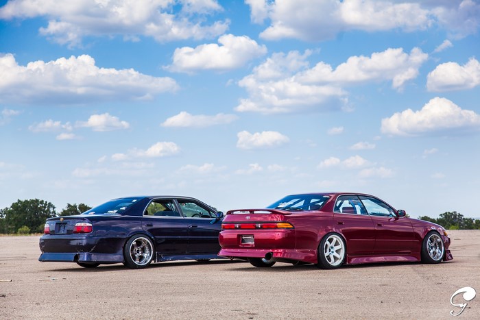 Two Toyota Mark II Chaser cars under a cloudy sky