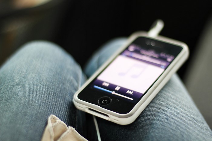 iPhone playing music on person's lap