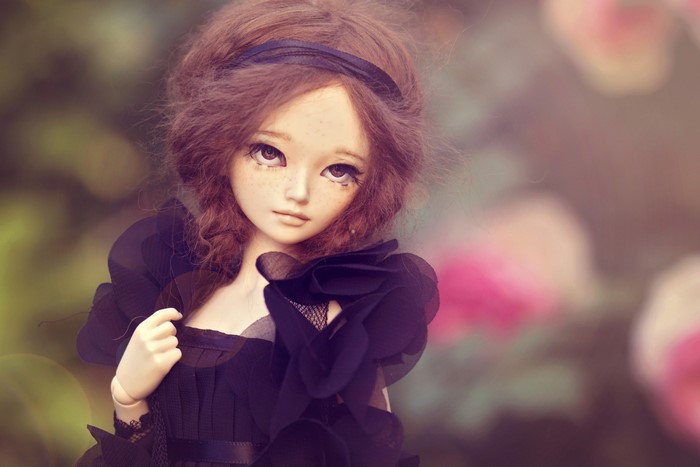 Doll with brown hair in a black dress