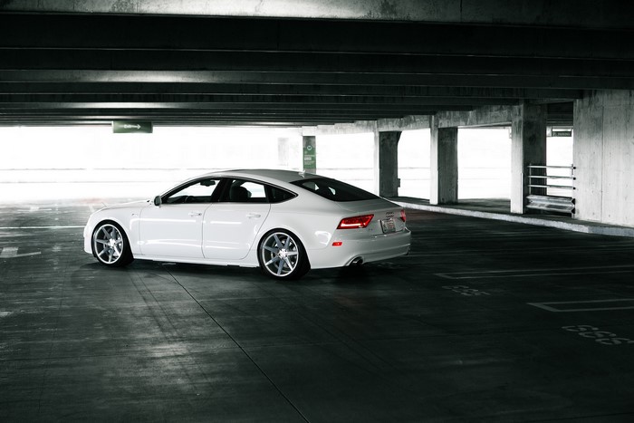 White Audi A7 parked in a concrete parking garage