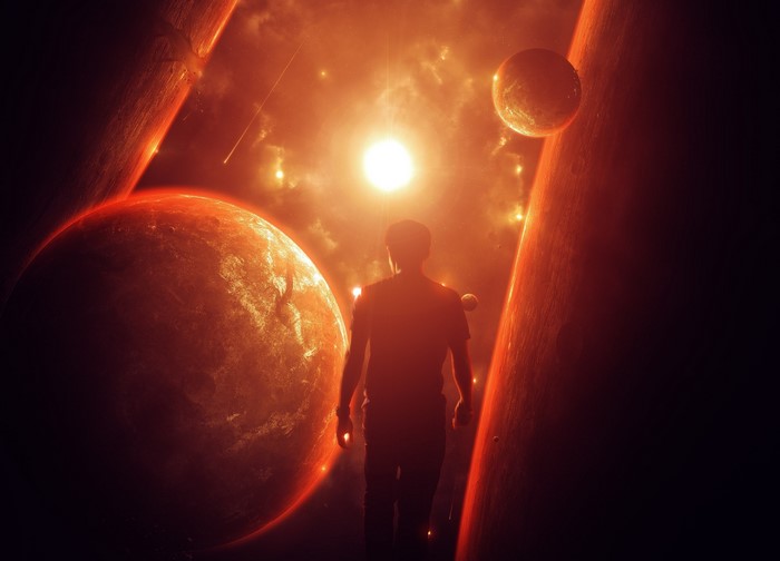 Man standing in a fantastic world with planets and stars