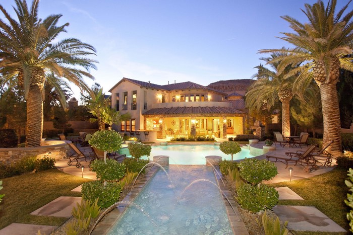 Luxury Villa with Pool and Palm Trees at Dusk