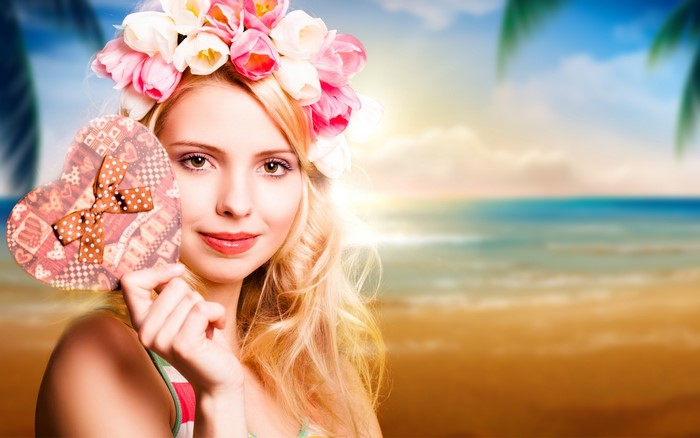 Woman with Flower Crown Holding Heart Gift on Beach