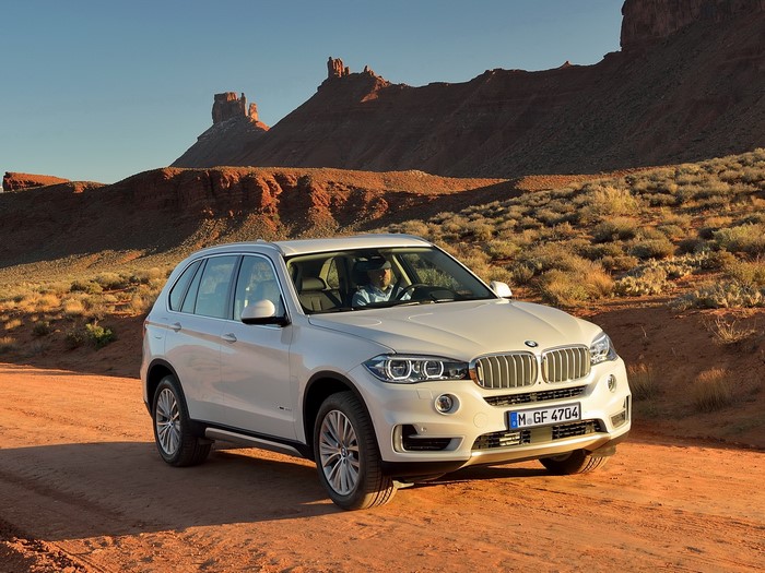 White BMW X5 in a desert landscape