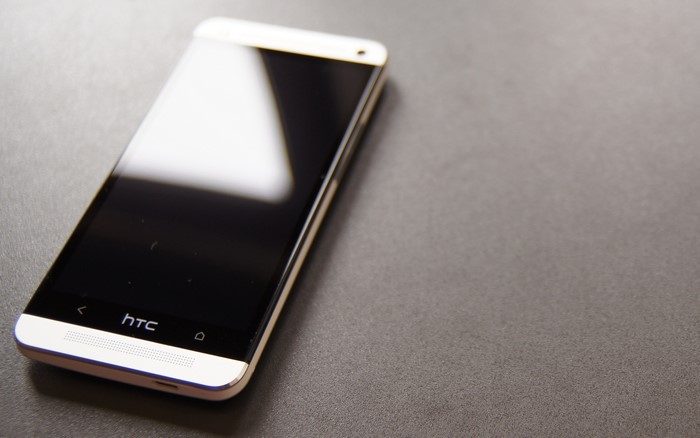HTC One smartphone on a dark surface
