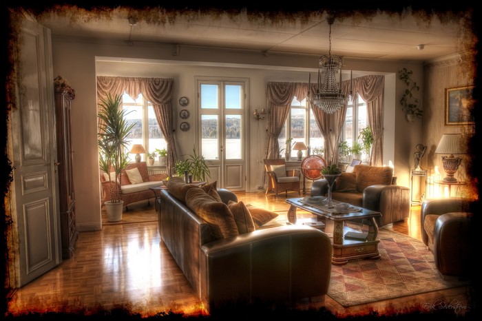 Interior of a living room with sofas and a chandelier