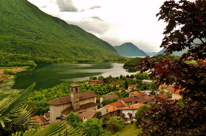 Lake Lugano with village and mountains in Lombardy, Italy