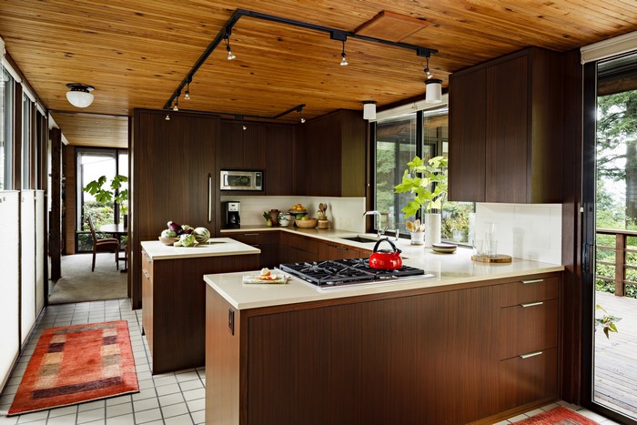 Modern kitchen with wood ceiling and dark cabinets