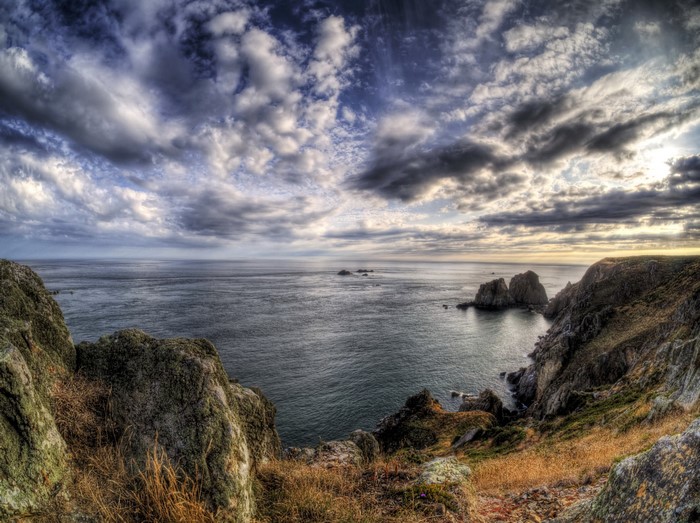 Rocky Coastline Overlooking the Sea Under Dramatic Clouds