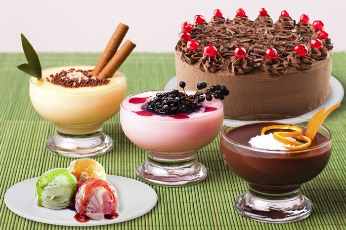 Dessert assortment with cake, ice cream, and puddings