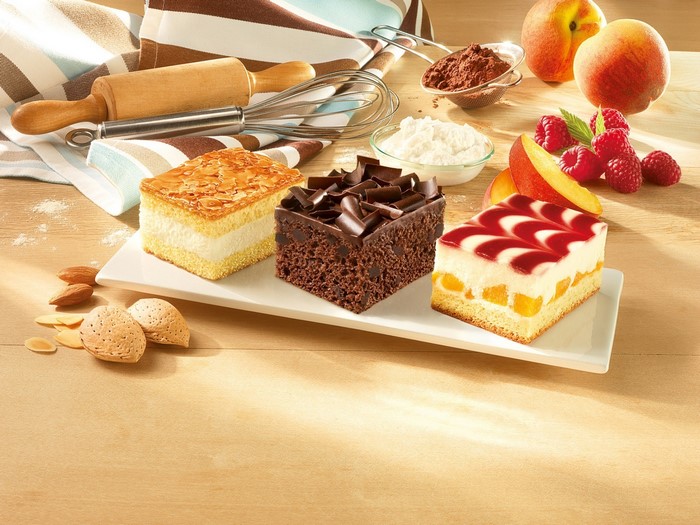 Three small cakes with baking ingredients