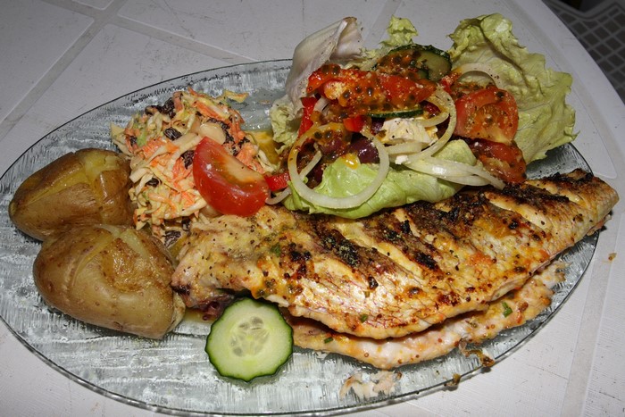 Grilled fish with potatoes and salad