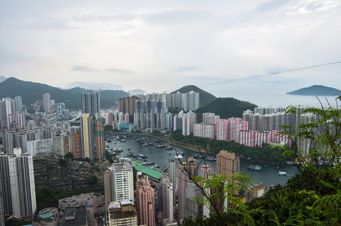 Aerial view of Hong Kong megapolis with harbor and mountains
