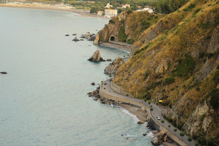 Coastline road with tunnel and sea in Sicily, Italy
