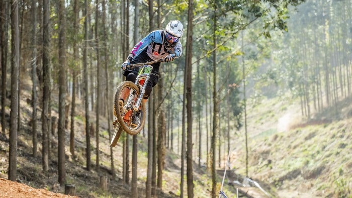 Mountain biker jumping in a forest