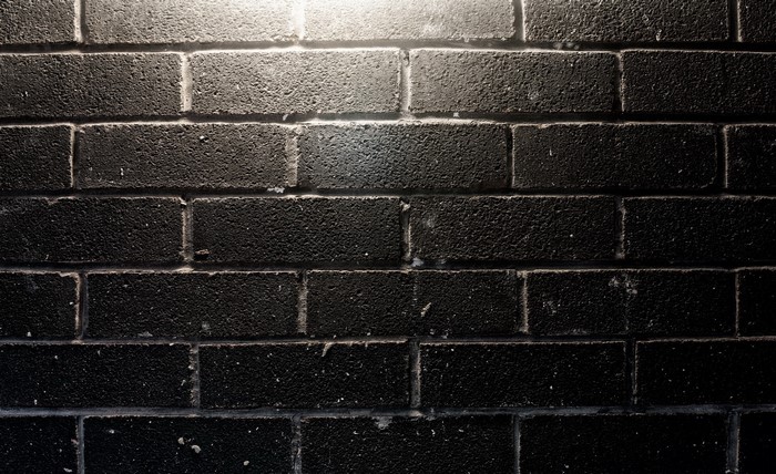 Black brick wall with light