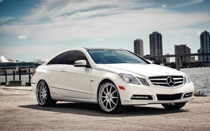 White Mercedes-Benz E-Class Coupe by the water