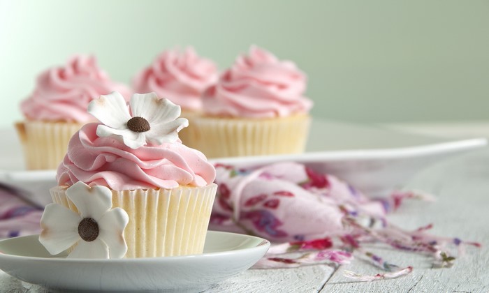 Pink frosted cupcakes with white flowers