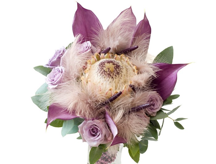 Purple and beige floral arrangement with feathers